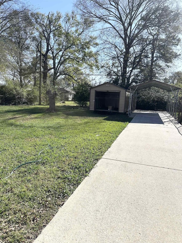 view of yard with an outbuilding, a garage, and a carport