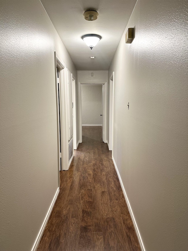 hall featuring dark wood-type flooring