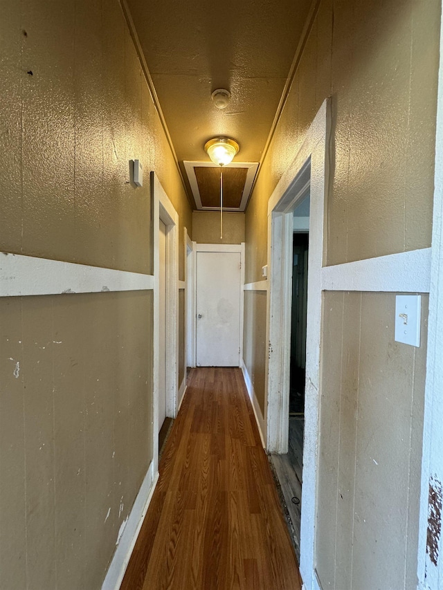 corridor with crown molding and hardwood / wood-style floors