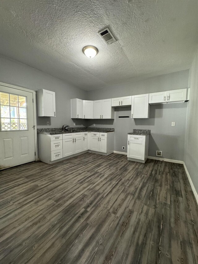 kitchen with white cabinets and dark hardwood / wood-style floors