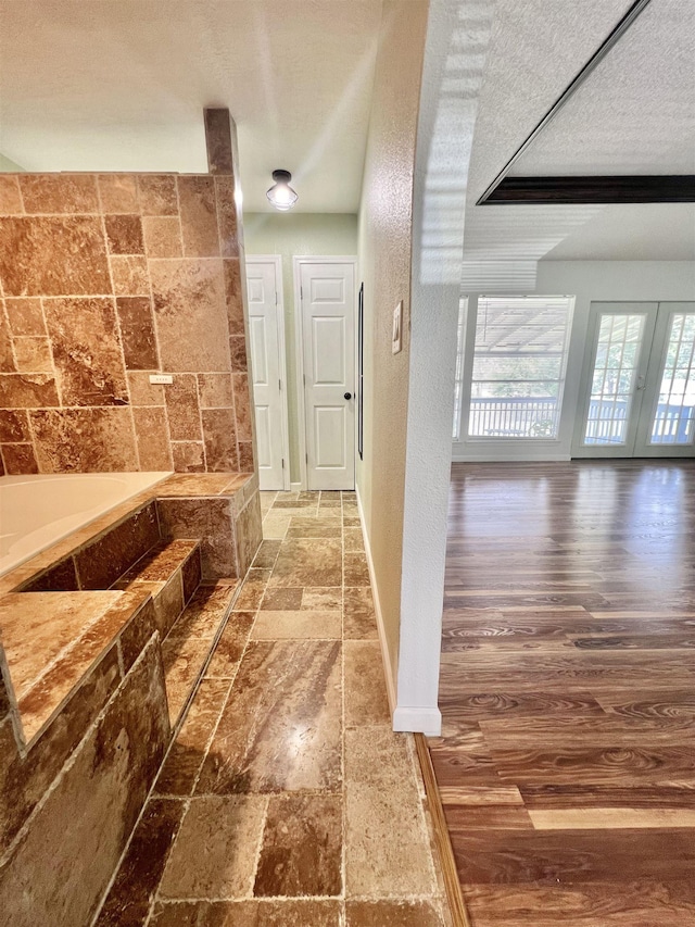 hallway with a textured ceiling and french doors