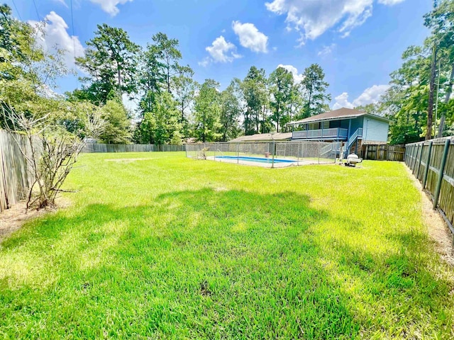 view of yard with a fenced in pool