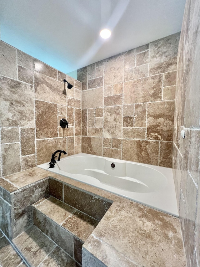 bathroom featuring tiled tub