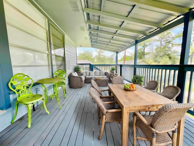 wooden terrace with an outdoor hangout area