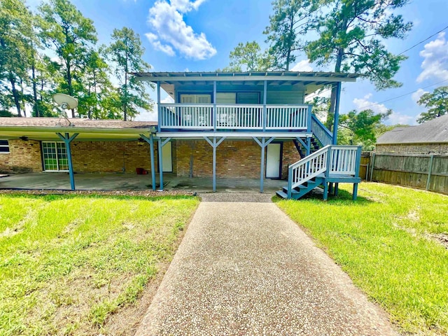 view of front of property featuring a front lawn and a patio