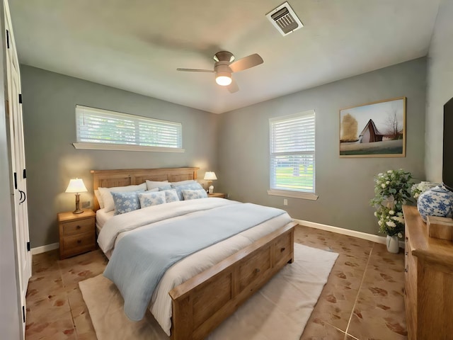 bedroom featuring light tile patterned floors and ceiling fan