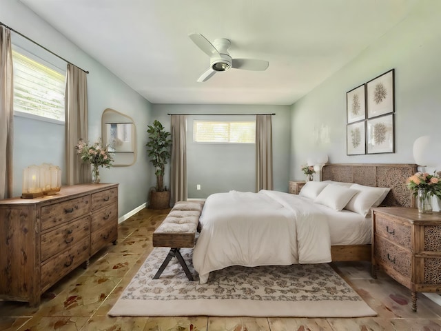 bedroom with ceiling fan and multiple windows