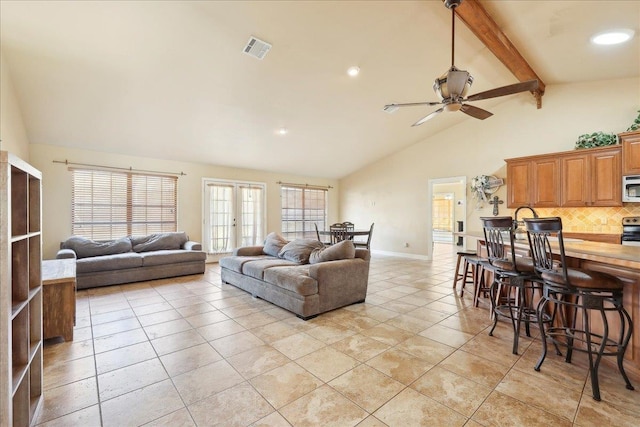 living room featuring light tile patterned floors, ceiling fan, beam ceiling, high vaulted ceiling, and french doors