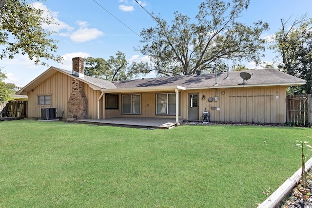 rear view of property featuring a patio area, a yard, and central air condition unit