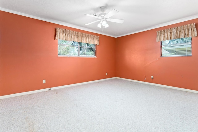 carpeted spare room featuring crown molding and ceiling fan