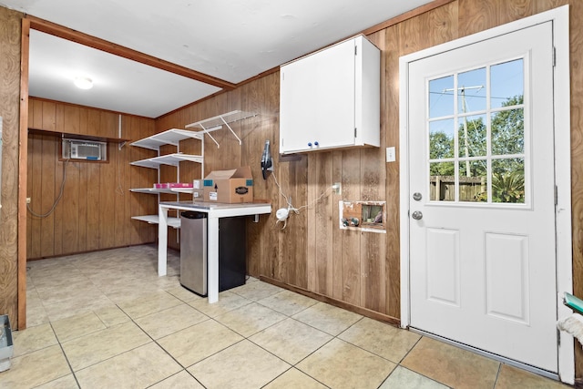 laundry area featuring wood walls and light tile patterned floors