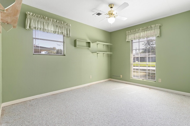 spare room featuring ceiling fan and carpet floors