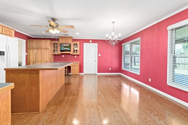 kitchen featuring crown molding, a healthy amount of sunlight, white refrigerator with ice dispenser, and light wood-type flooring