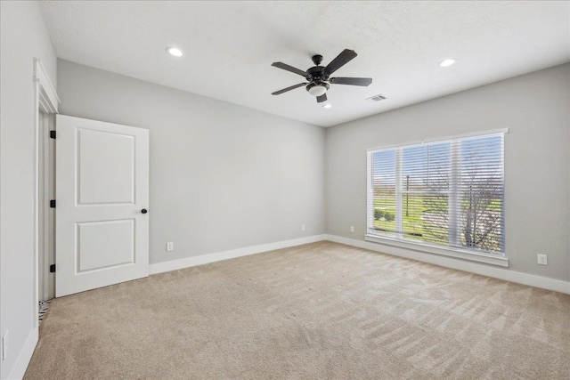 empty room with visible vents, a ceiling fan, recessed lighting, carpet, and baseboards