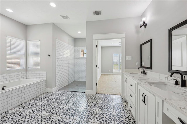 bathroom featuring walk in shower, visible vents, and a sink