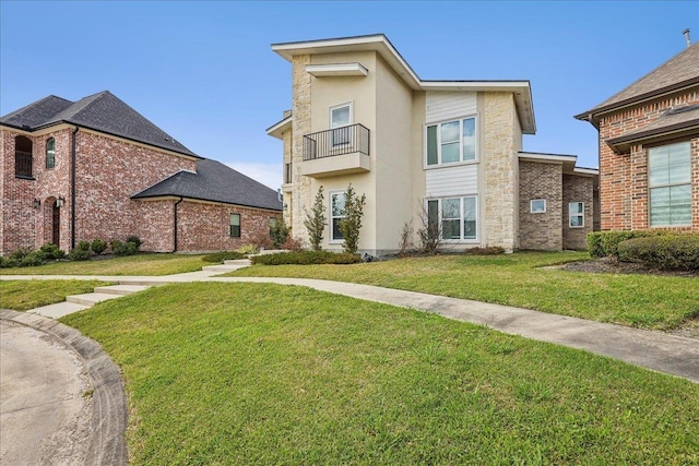 view of front of property with stucco siding and a front lawn