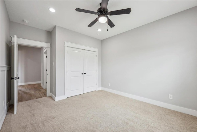 unfurnished bedroom featuring baseboards, carpet, ceiling fan, recessed lighting, and a closet