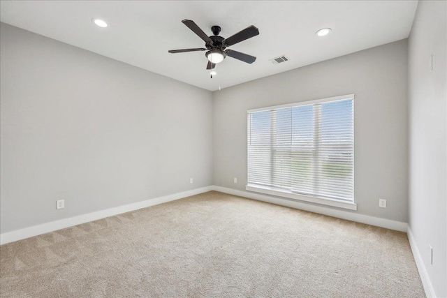 carpeted spare room featuring recessed lighting, visible vents, baseboards, and a ceiling fan