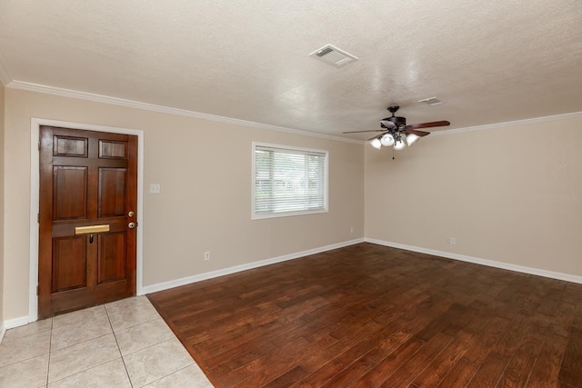 foyer with ceiling fan, crown molding, a textured ceiling, and light hardwood / wood-style flooring