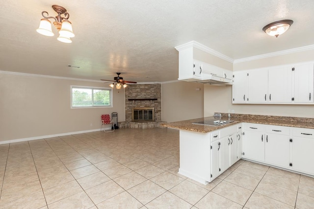 kitchen with white cabinets, kitchen peninsula, ceiling fan, and dark stone countertops