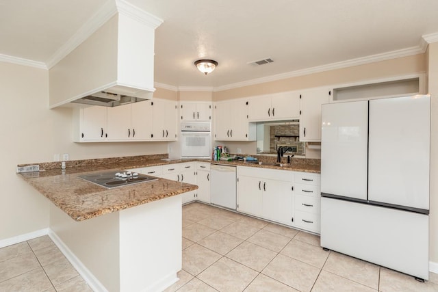 kitchen with kitchen peninsula, light stone counters, white appliances, white cabinets, and light tile patterned flooring