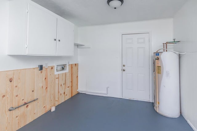 laundry room featuring wooden walls, hookup for a washing machine, cabinets, and gas water heater