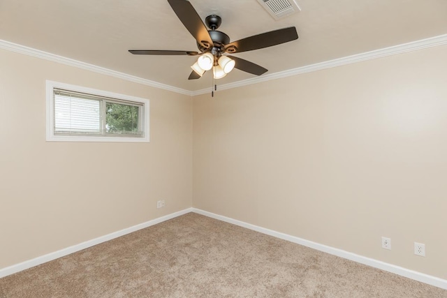 spare room with light colored carpet, ceiling fan, and crown molding