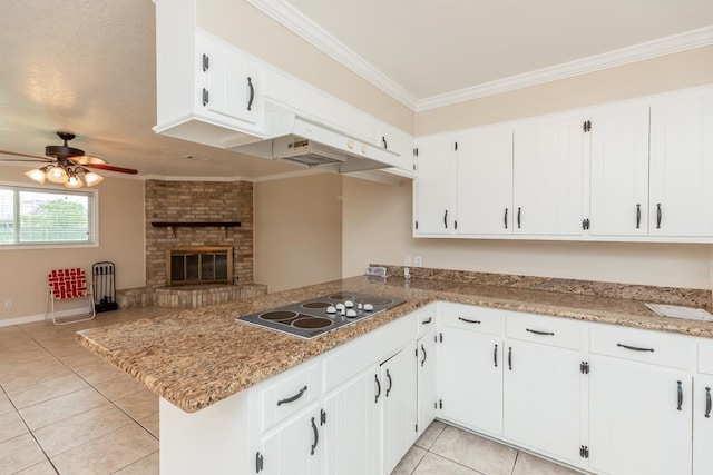 kitchen with kitchen peninsula, ceiling fan, crown molding, electric stovetop, and white cabinetry