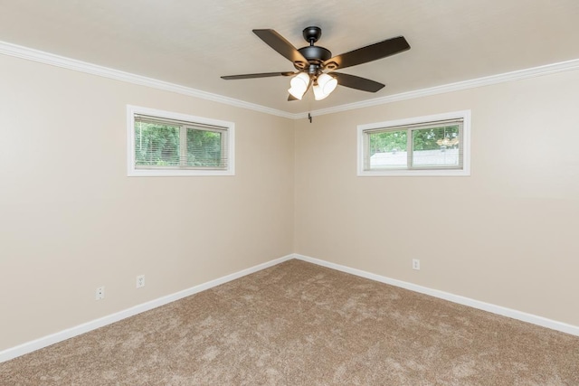 carpeted spare room with crown molding and ceiling fan