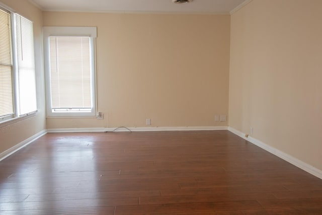 unfurnished room featuring dark hardwood / wood-style flooring and ornamental molding