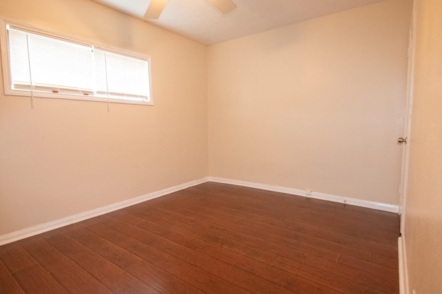 empty room with ceiling fan and dark wood-type flooring