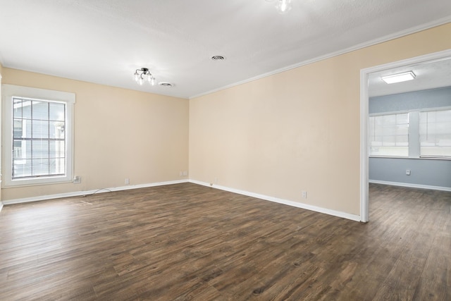 3140 S Drive Drive, Groves, TX 77619 - spare room featuring dark wood-style floors, crown molding, and baseboards