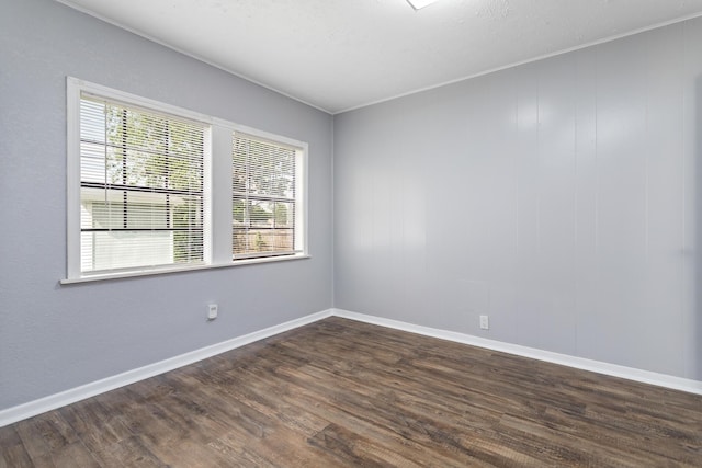 3140 S Drive Drive, Groves, TX 77619 - unfurnished room featuring healthy amount of natural light, dark wood-style flooring, and baseboards