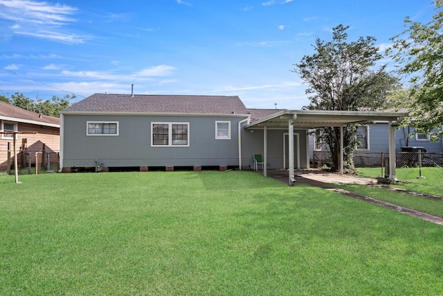 3140 S Drive Drive, Groves, TX 77619 - back of house featuring a carport and a shingled roof