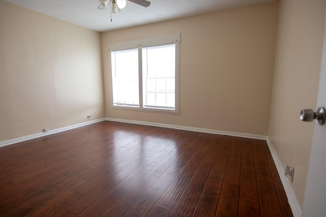 empty room with ceiling fan and dark wood-type flooring