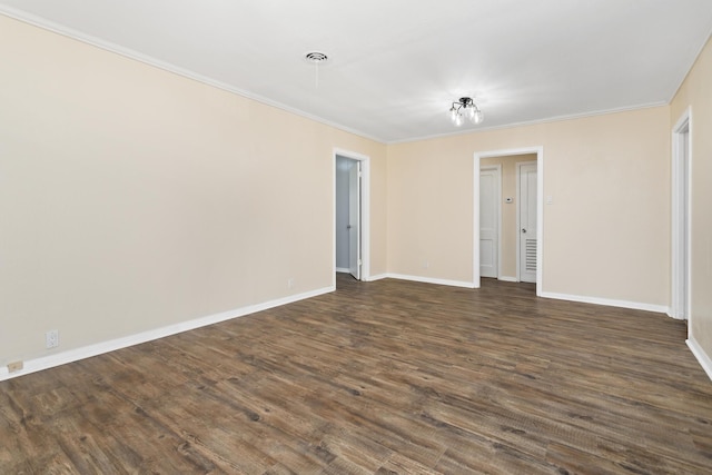 3140 S Drive Drive, Groves, TX 77619 - spare room featuring crown molding, baseboards, and dark wood-style flooring