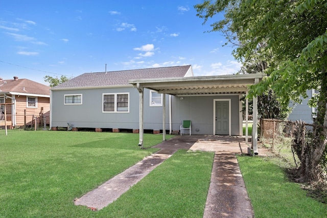 3140 S Drive Drive, Groves, TX 77619 - rear view of house with concrete driveway, a carport, and a shingled roof