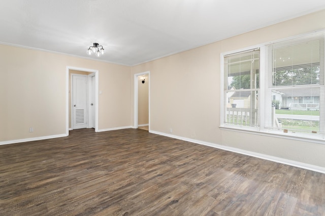 3140 S Drive Drive, Groves, TX 77619 - empty room featuring dark wood-style floors, baseboards, and ornamental molding