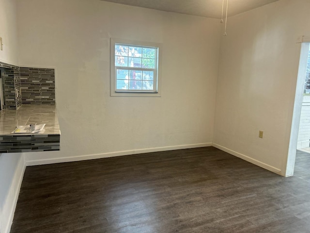 unfurnished room featuring dark hardwood / wood-style flooring