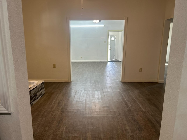 empty room with dark hardwood / wood-style flooring