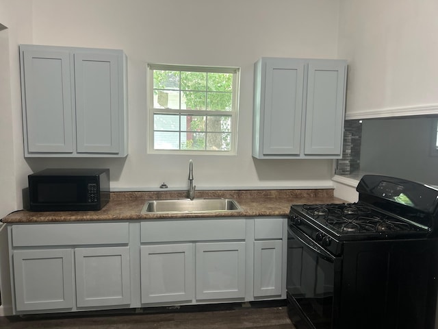 kitchen with white cabinets, sink, and black appliances