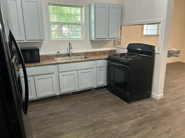 kitchen featuring sink, black appliances, and dark hardwood / wood-style floors