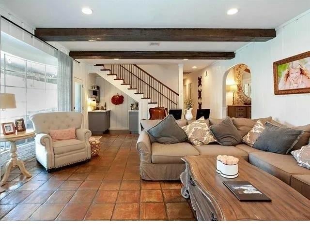 tiled living room with beam ceiling