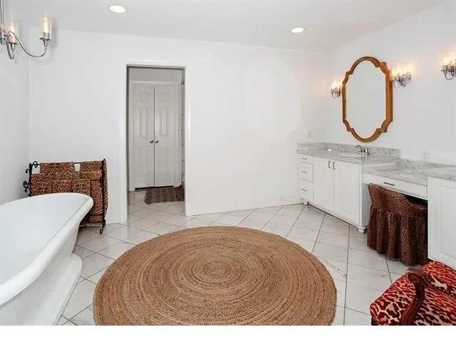 bathroom featuring a tub and vanity