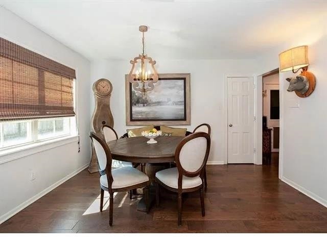 dining room featuring a notable chandelier and dark hardwood / wood-style floors