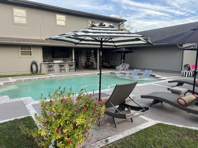 view of pool with a patio area and an outdoor bar