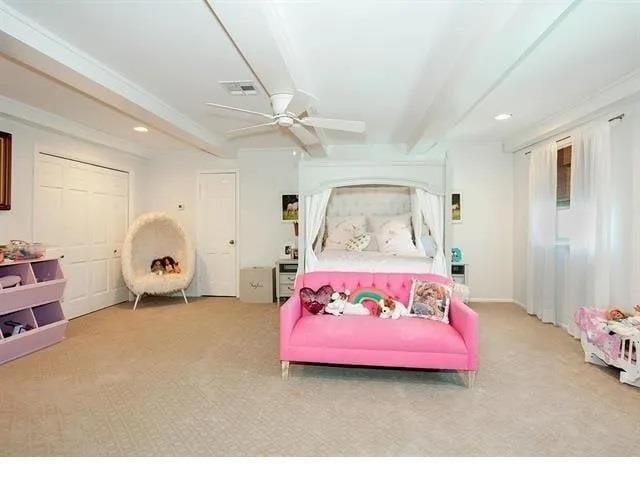 bedroom with ceiling fan, beamed ceiling, light carpet, and ornamental molding