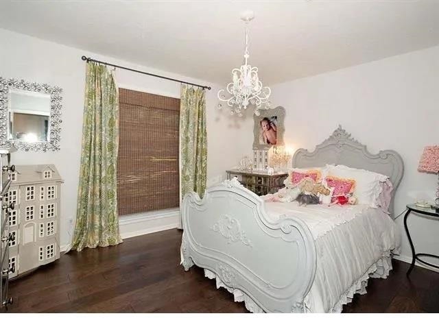 bedroom with dark hardwood / wood-style flooring