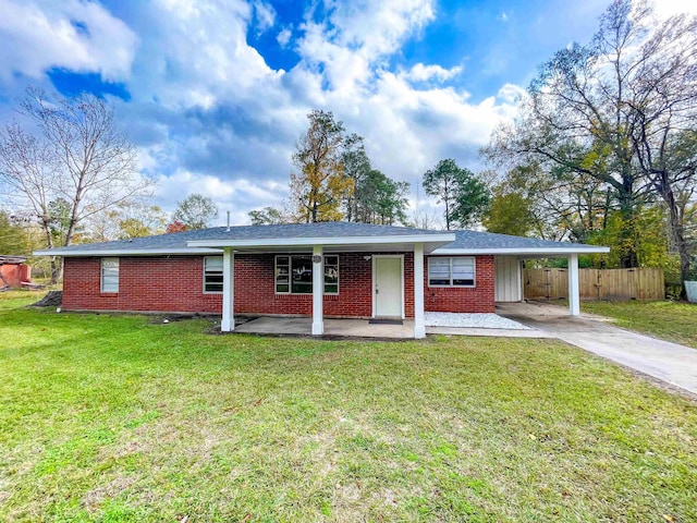 ranch-style house featuring a front yard and a carport