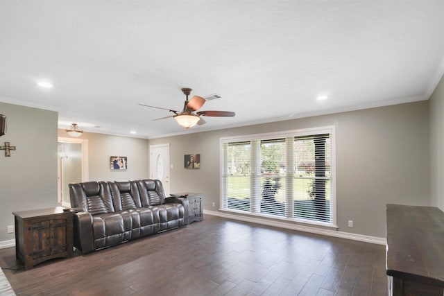 living area featuring dark wood-style floors, visible vents, ornamental molding, and baseboards